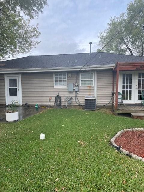 rear view of house featuring a yard, central AC, and a wooden deck