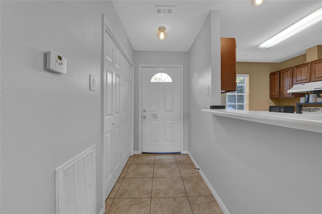 doorway to outside featuring a healthy amount of sunlight and light tile patterned floors