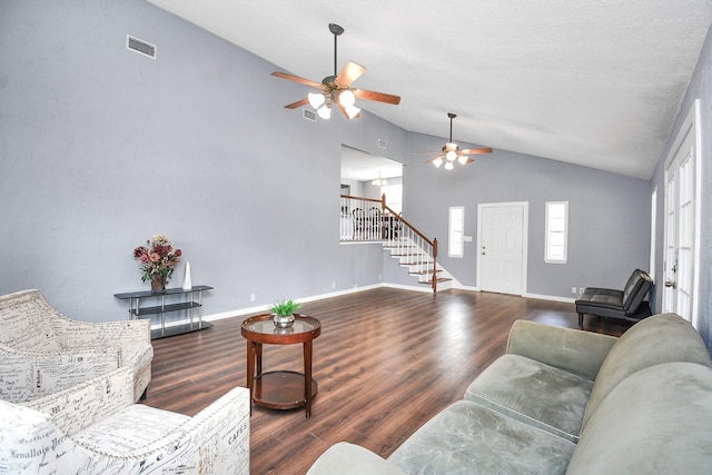 living room with a textured ceiling, dark hardwood / wood-style floors, and vaulted ceiling