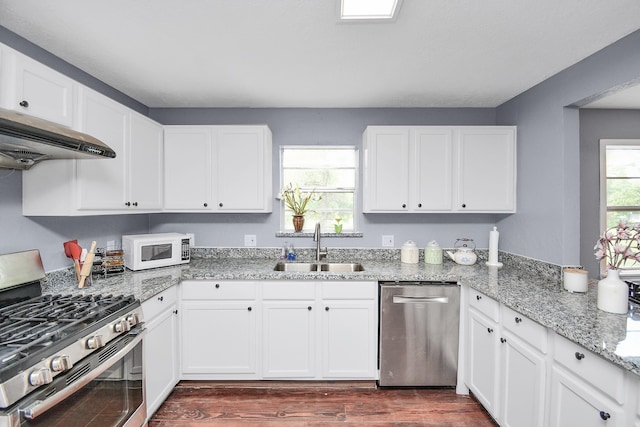 kitchen featuring white cabinets, sink, stainless steel appliances, and dark wood-type flooring