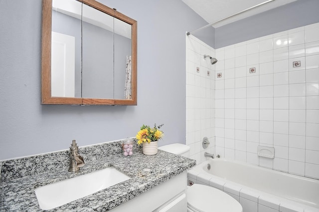 full bathroom with vanity, toilet, and tiled shower / bath