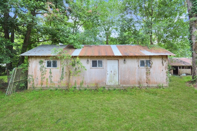 view of outdoor structure featuring a lawn