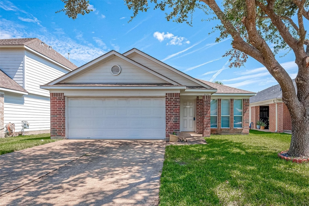 view of front of house with a front yard and a garage