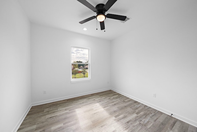 spare room with ceiling fan and light hardwood / wood-style floors