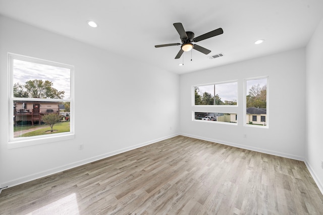 empty room with light wood-type flooring and ceiling fan