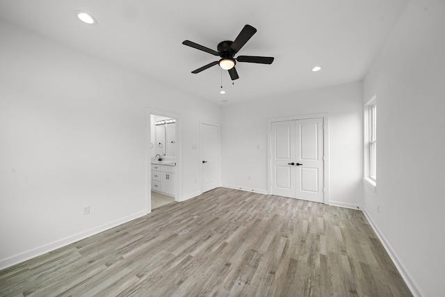 empty room with ceiling fan and light wood-type flooring