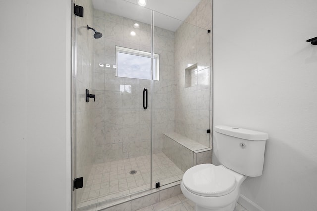 bathroom with a shower with door and toilet