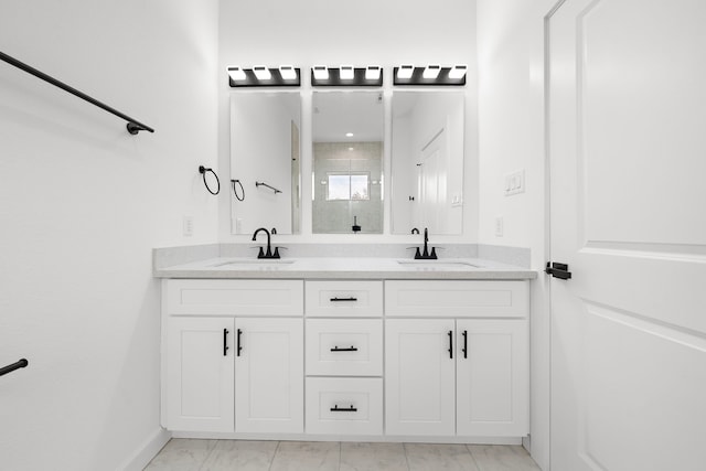 bathroom with vanity and a shower with shower door