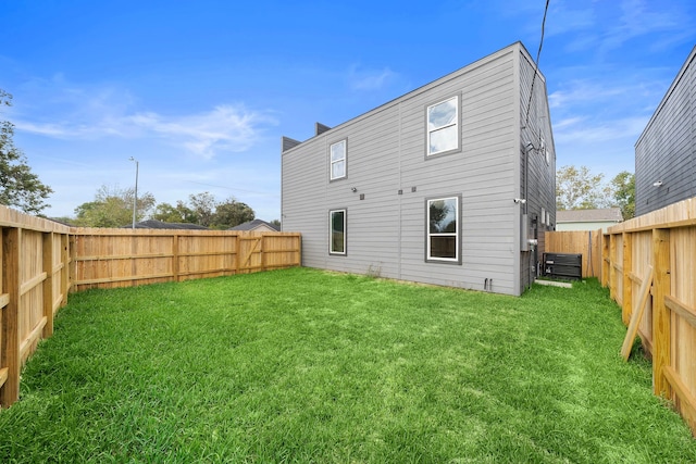 rear view of house featuring a yard