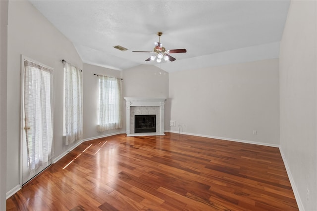 unfurnished living room featuring hardwood / wood-style flooring, ceiling fan, and vaulted ceiling