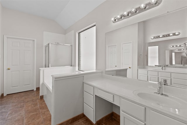 bathroom featuring tile patterned floors, vanity, vaulted ceiling, and independent shower and bath