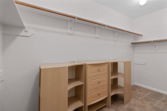 spacious closet with tile patterned floors