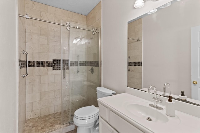 bathroom with toilet, vanity, and walk in shower