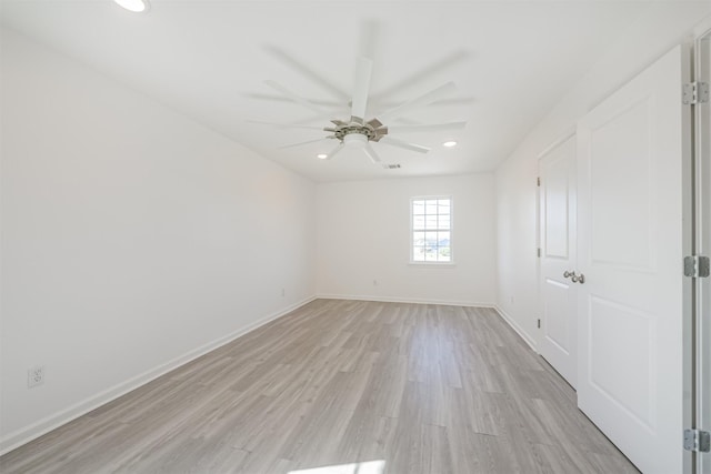 spare room featuring ceiling fan and light hardwood / wood-style flooring