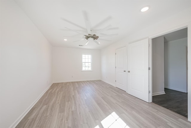 unfurnished bedroom with ceiling fan, a closet, and light hardwood / wood-style flooring