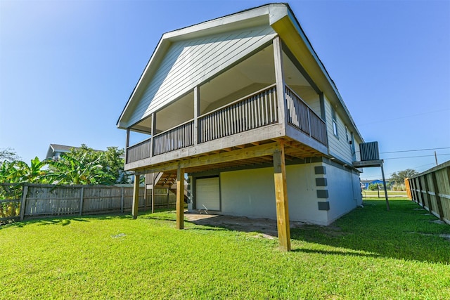 rear view of property featuring a deck and a yard