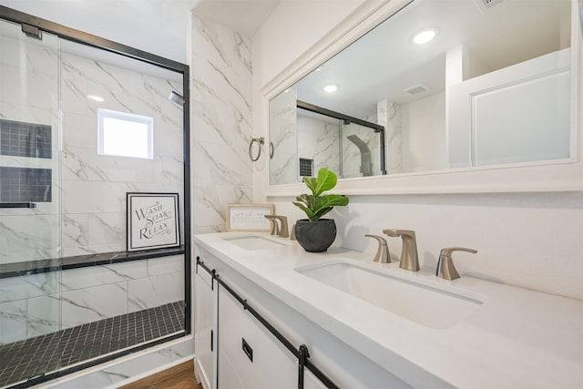 bathroom with vanity, hardwood / wood-style flooring, and a shower with door