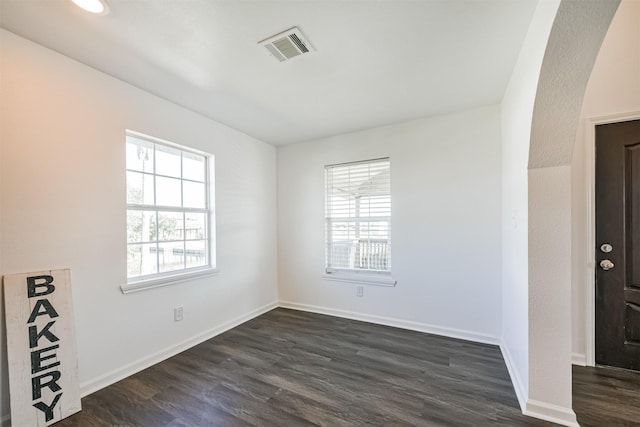 spare room with dark hardwood / wood-style floors