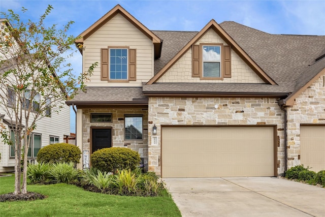 craftsman-style house featuring a garage and a front lawn