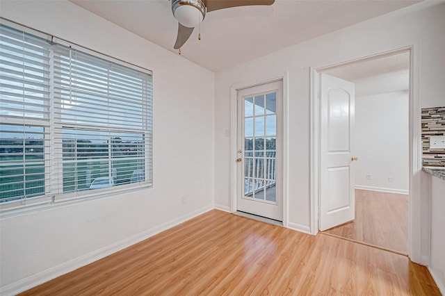 spare room with ceiling fan and light wood-type flooring