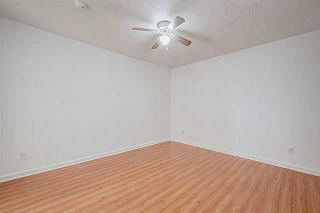 unfurnished room featuring ceiling fan, light hardwood / wood-style floors, and a textured ceiling