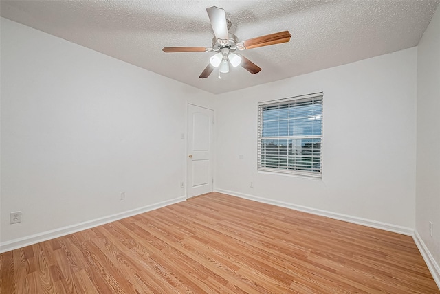 unfurnished room with ceiling fan, light hardwood / wood-style flooring, and a textured ceiling