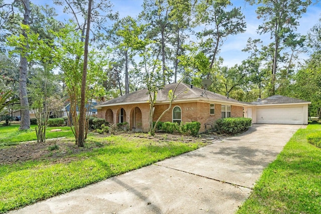 ranch-style home featuring a front yard and a garage