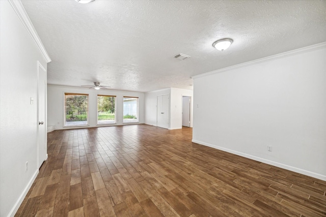 unfurnished living room featuring crown molding, dark hardwood / wood-style flooring, and a textured ceiling