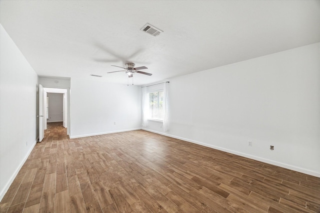 spare room with hardwood / wood-style floors and ceiling fan