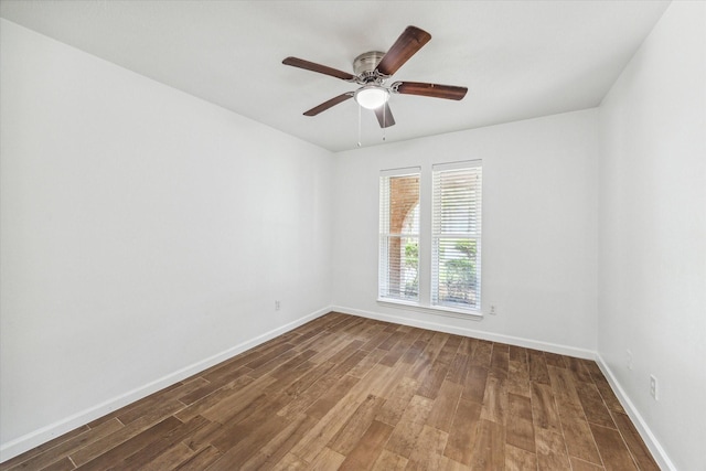 empty room with dark hardwood / wood-style floors and ceiling fan