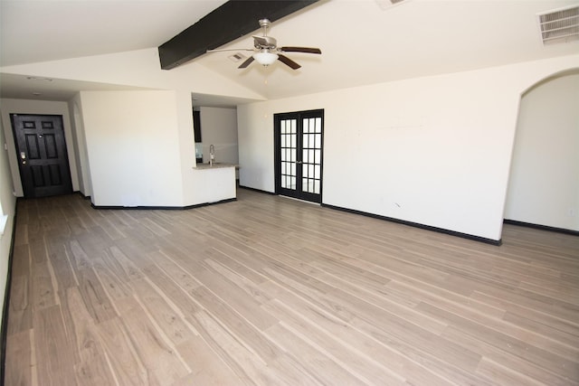 interior space with vaulted ceiling with beams, light hardwood / wood-style floors, ceiling fan, and french doors