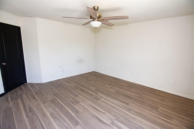 spare room with hardwood / wood-style flooring and ceiling fan