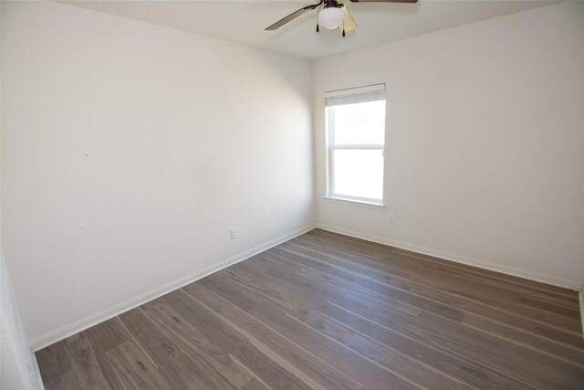 empty room with ceiling fan and dark wood-type flooring