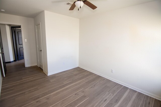 spare room featuring ceiling fan and dark hardwood / wood-style flooring