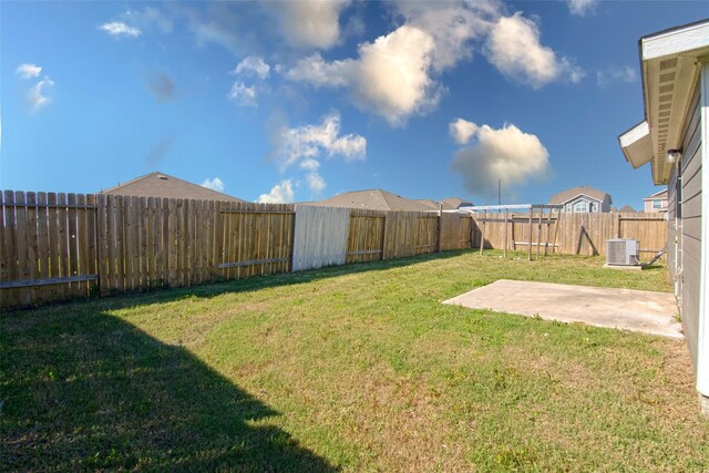 view of yard featuring central AC unit and a patio