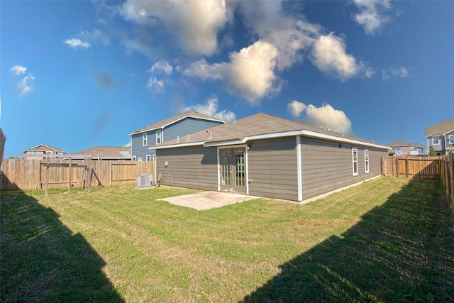 back of property with a lawn, cooling unit, and a patio