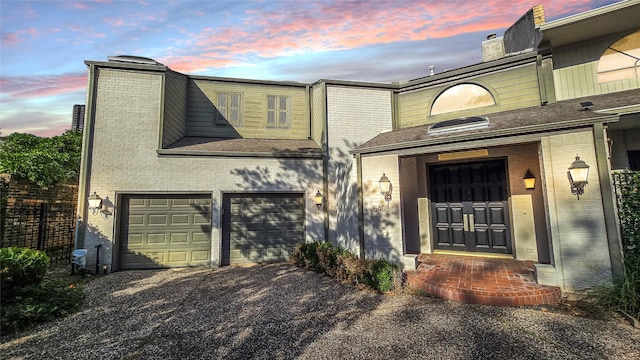 exterior entry at dusk with a garage