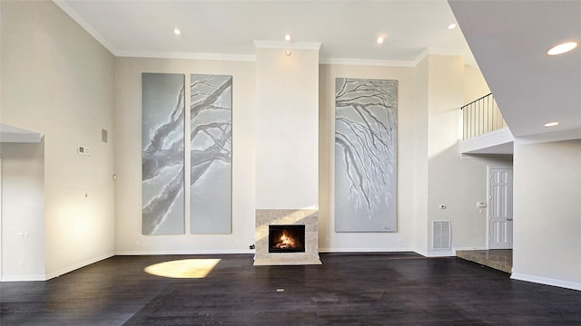 unfurnished living room with crown molding and dark wood-type flooring