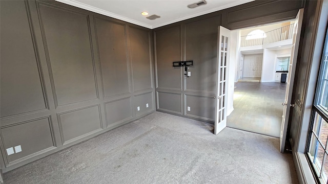 unfurnished room featuring light colored carpet and ornamental molding