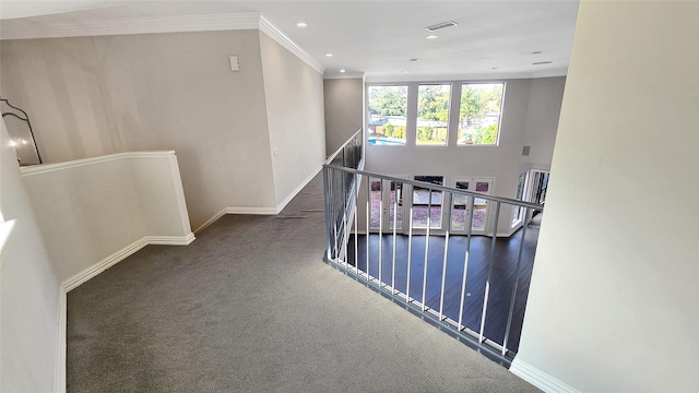 corridor featuring dark carpet and ornamental molding