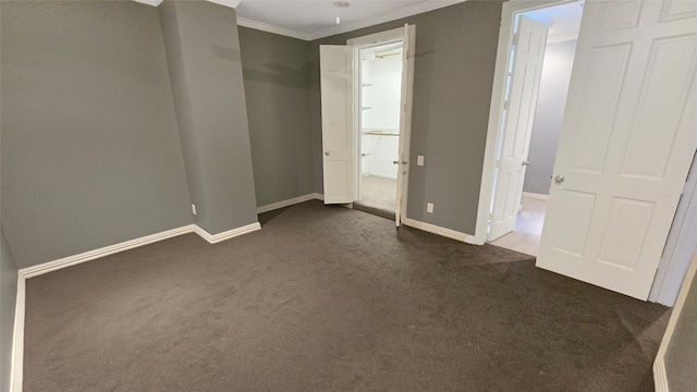 unfurnished bedroom with ornamental molding and dark colored carpet