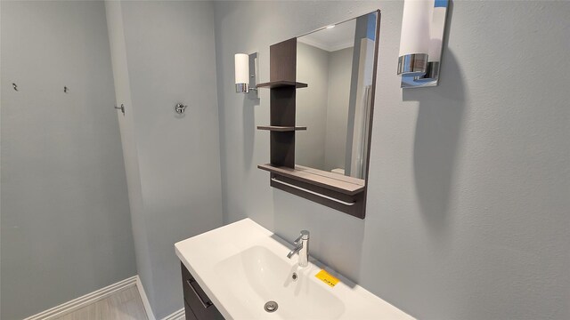 bathroom featuring vanity and ornamental molding