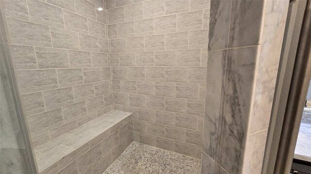 bathroom with a tile shower