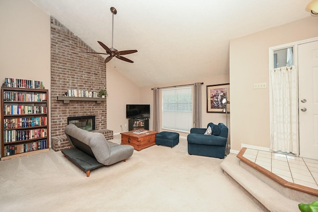 living room with ceiling fan, a fireplace, carpet floors, and high vaulted ceiling