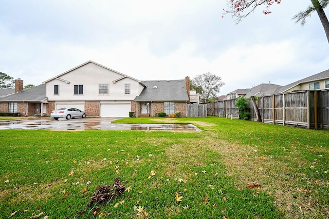 16908 Timberwork Rd, Spring, TX 77379 - rear view of property featuring a garage, brick siding, and concrete driveway