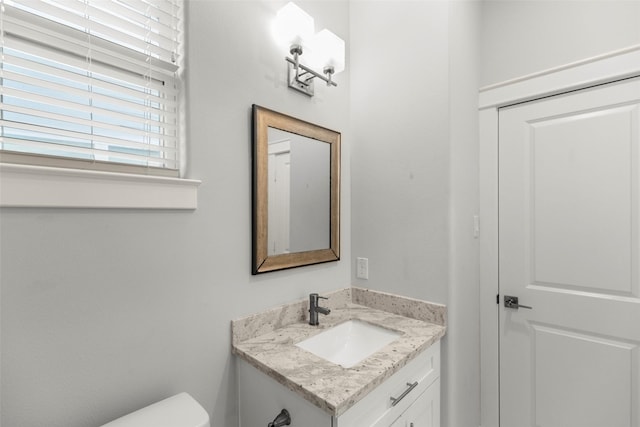 bathroom with vanity and toilet