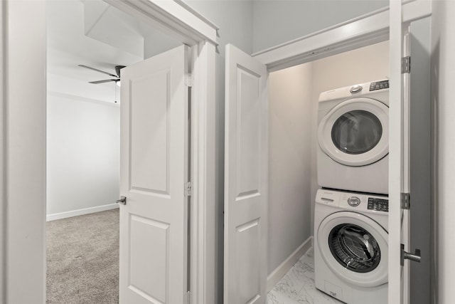 laundry area with light colored carpet, ceiling fan, and stacked washer / drying machine