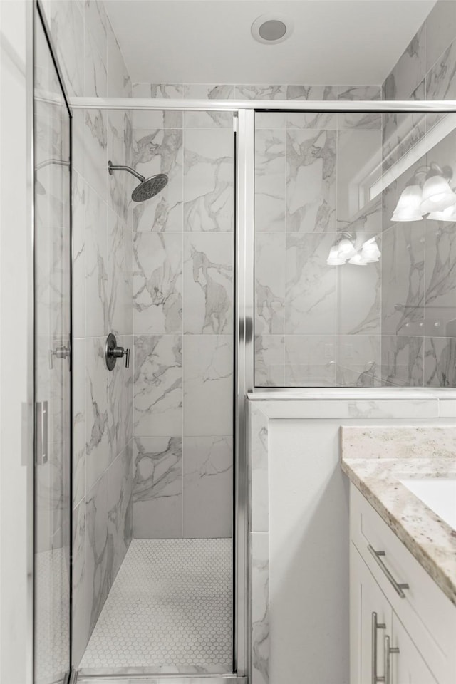 bathroom with vanity and a shower with shower door