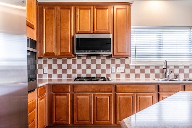 kitchen featuring backsplash, sink, and stainless steel appliances