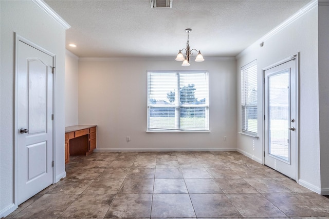 unfurnished dining area featuring a chandelier, a textured ceiling, and ornamental molding